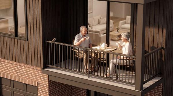 Elderly couple enjoying tea on townhome balcony